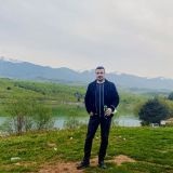 portrait-young-man-standing-mountain-against-sky (1)